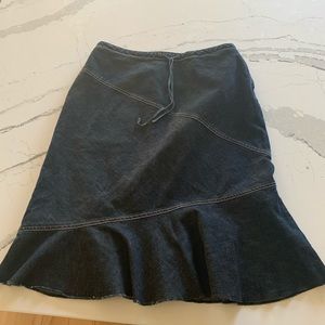 Super Cute Jean skirt with tie in the front. Zipper on the side. Some stretch.
